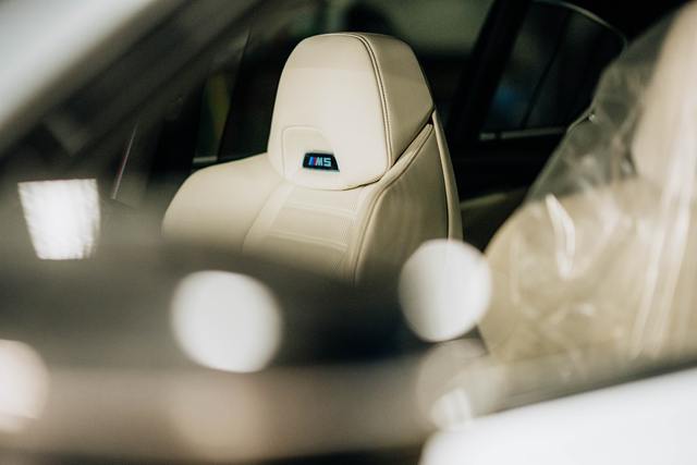 Light leather BMW M5 front seat with the M5 logo on the headrest