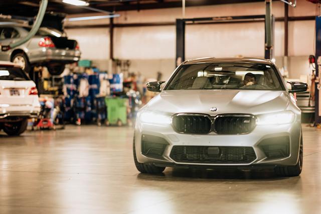 Silver BMW M5 pulling into the Turning Wrenches service bay