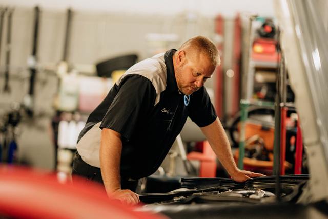 Owner Levi Johnson inspecting an engine bay