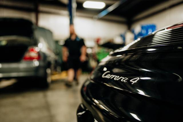 Carrera 4 script on the rear of a black Porsche 911