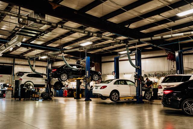 Mercedes-Benz sedans and SUVs on lifts in the Turning Wrenches service bays