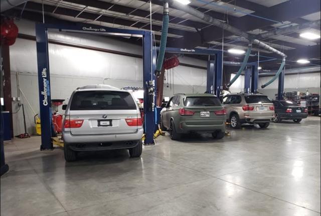 Silver BMW X5 and other SUVs parked in the Turning Wrenches service bays